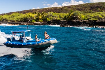 People riding in blue dive boat