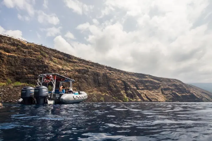 snorkel boat sitting in water off coast of Hawaii