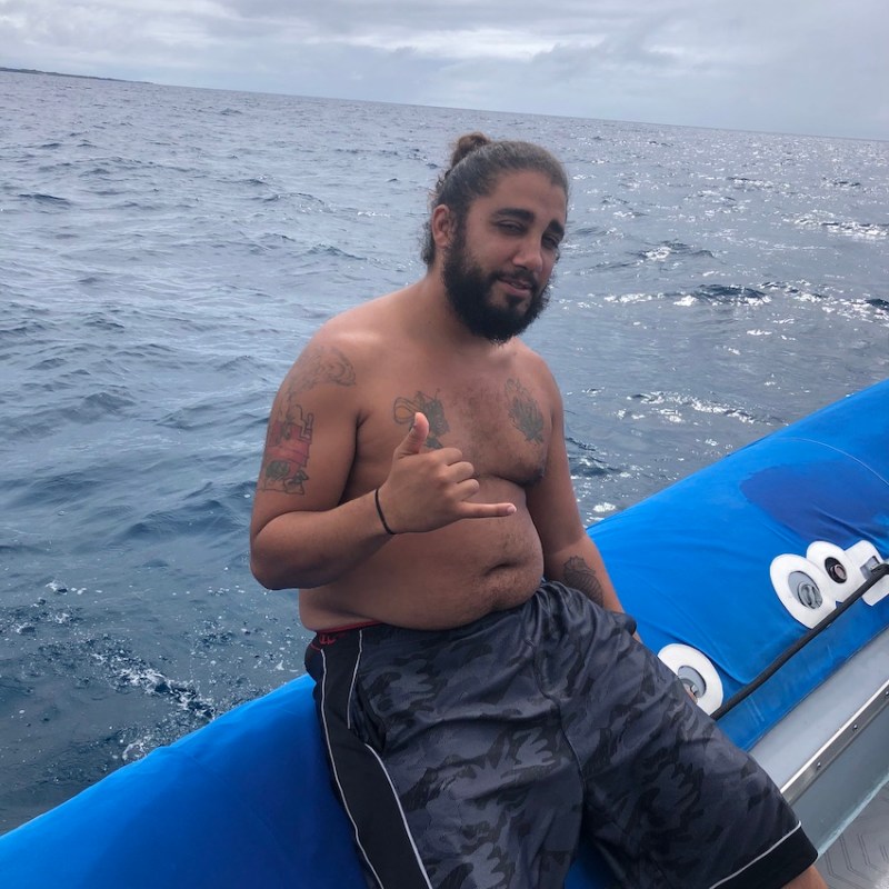 a man holding a snow board in the water