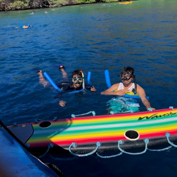 a group of people in a small boat in a body of water