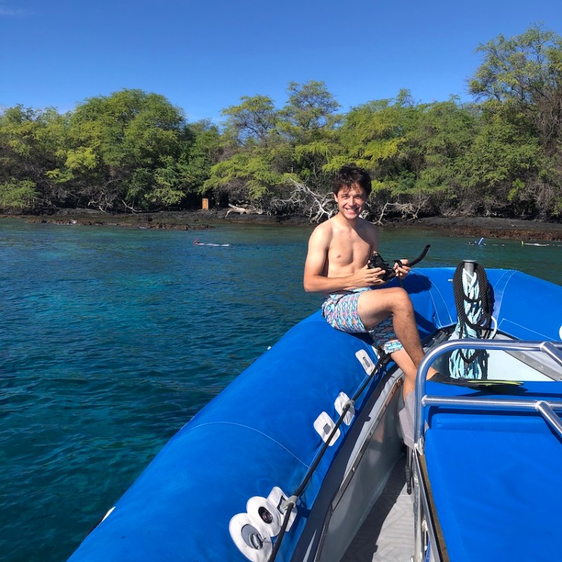 a person in a blue boat on a body of water