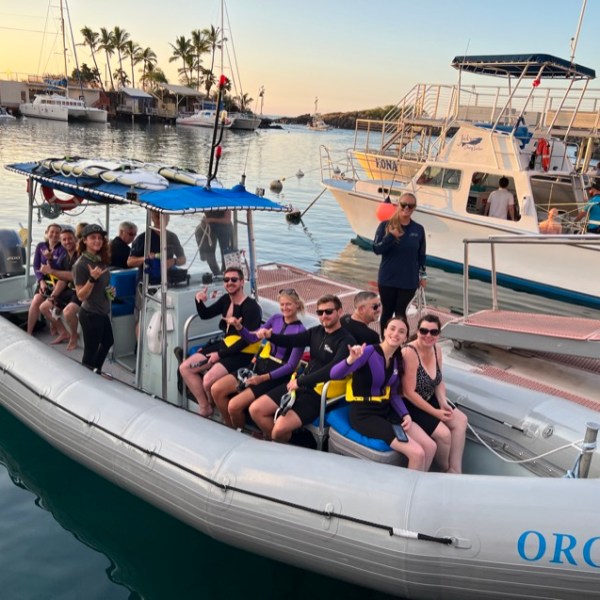 a group of people in a small boat in a body of water