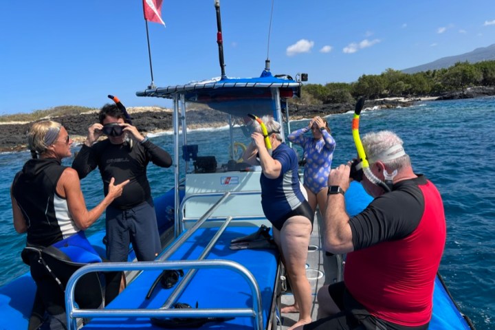 a group of people in a boat on a body of water