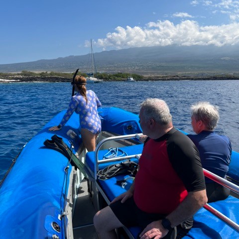 a group of people in a boat on a body of water