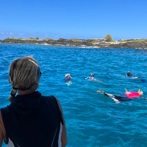 a group of people in a boat on a body of water
