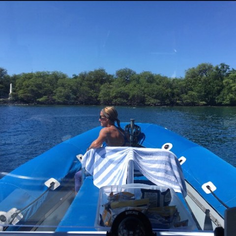 a man in a blue boat on a body of water