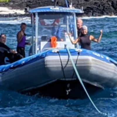a group of people in a small boat in a body of water