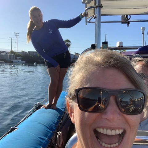 a woman wearing sunglasses posing for the camera