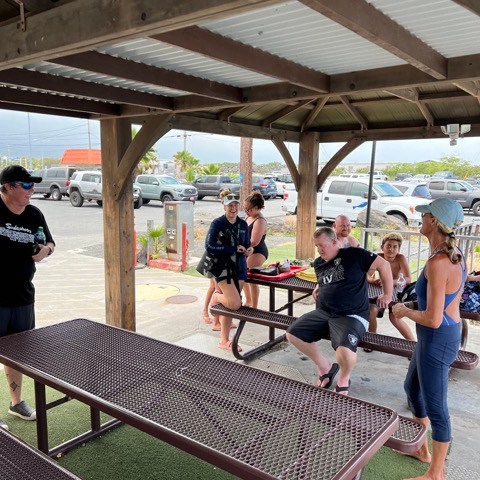 a group of people sitting at a picnic table