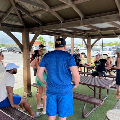 a group of people sitting at a picnic table