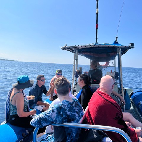 a group of people in a boat on a body of water