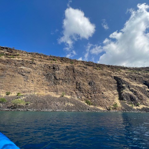 a body of water with a mountain in the background