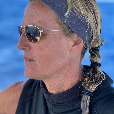 a man wearing a hat and sunglasses