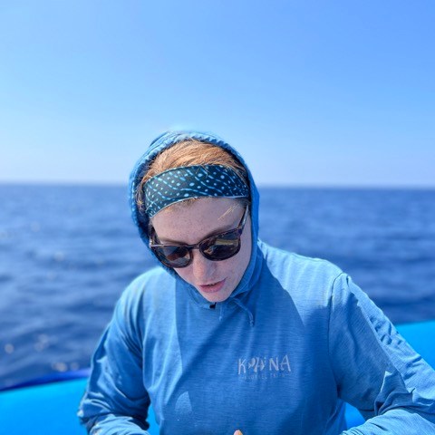 a man standing next to a body of water