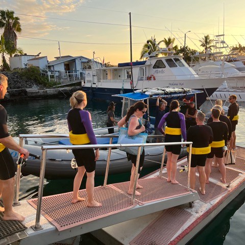 a group of people on a boat in the water
