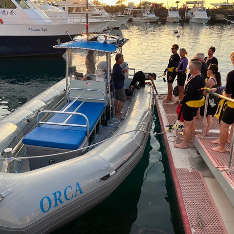 a group of people on a boat in the water