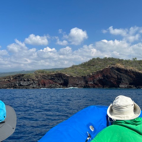 a group of people standing next to a body of water
