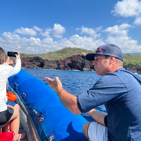 a man and a woman standing next to a body of water
