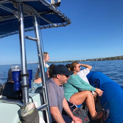 a person sitting in a boat on a body of water