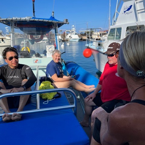 a group of people sitting on a boat