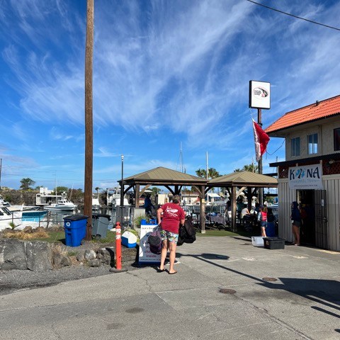 a group of people standing in a parking lot