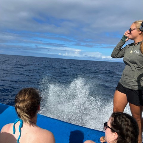 a man and a woman standing in front of a body of water
