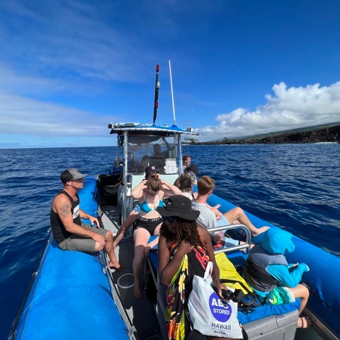 a group of people in a boat on a body of water