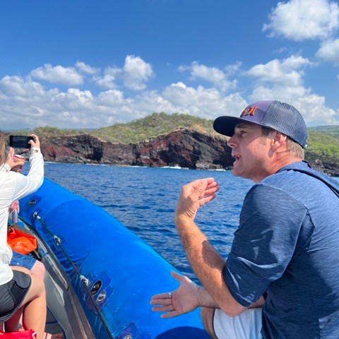 a group of people standing next to a body of water
