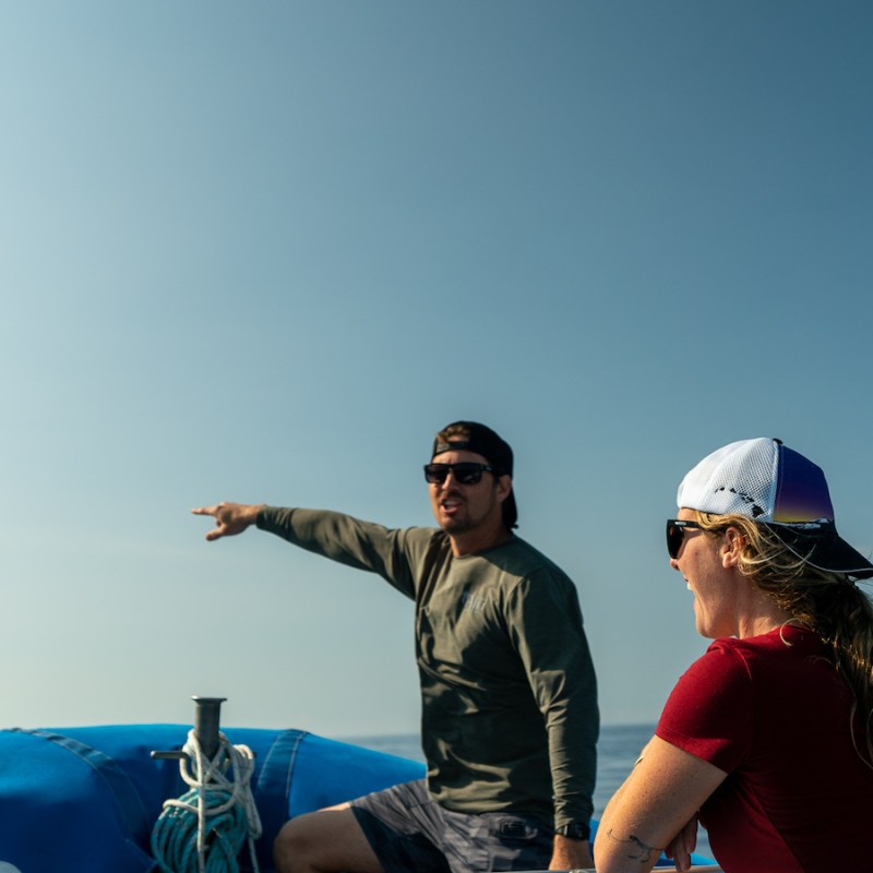 a man standing next to a body of water