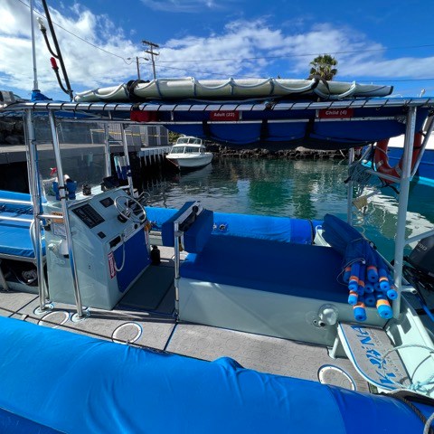 a blue boat docked in the water