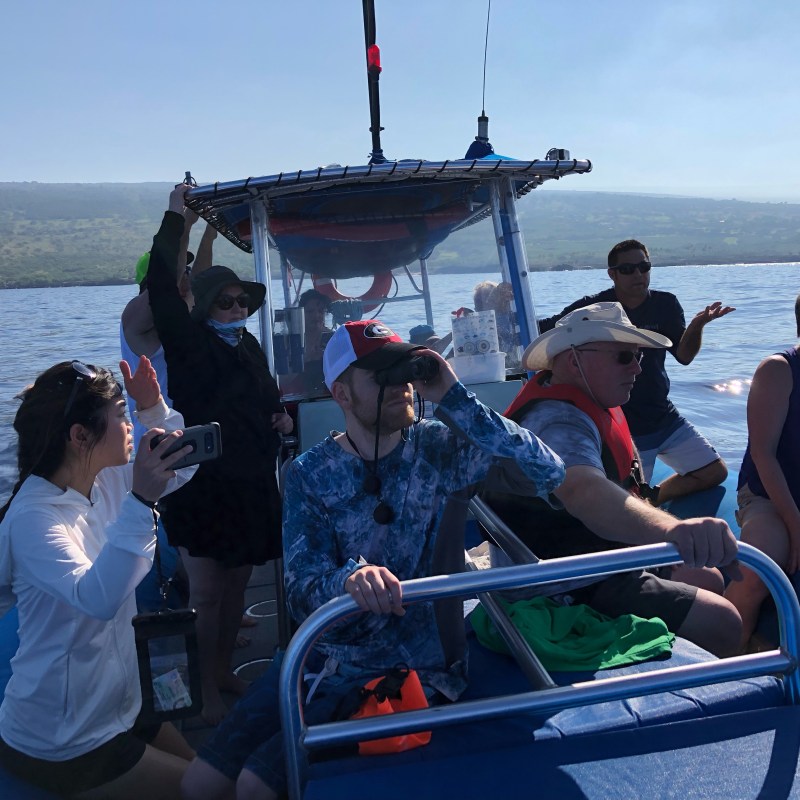 a group of people in a boat on a body of water
