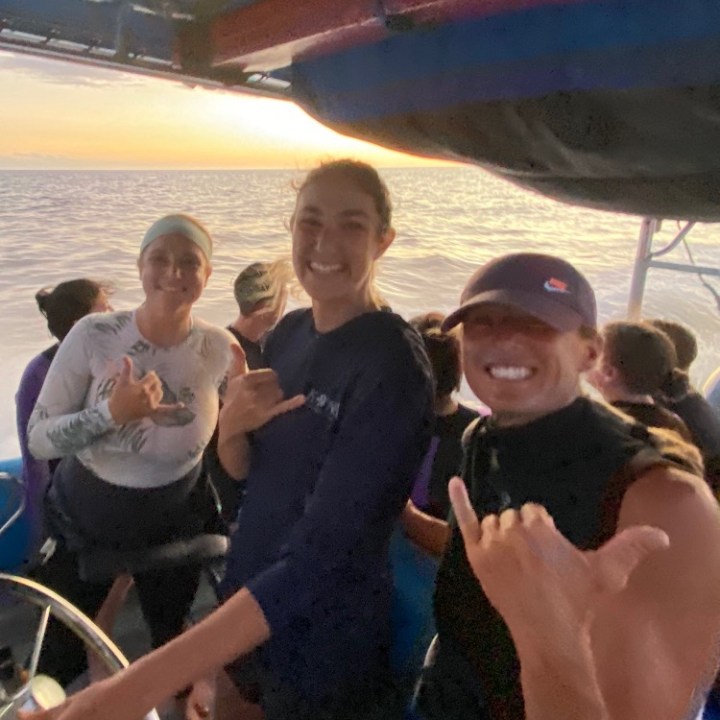 a group of people standing around a plane