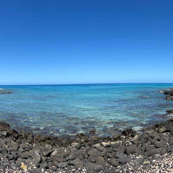 a rocky beach next to a body of water