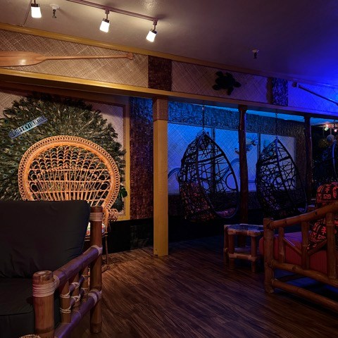 a living room filled with furniture and purple lights