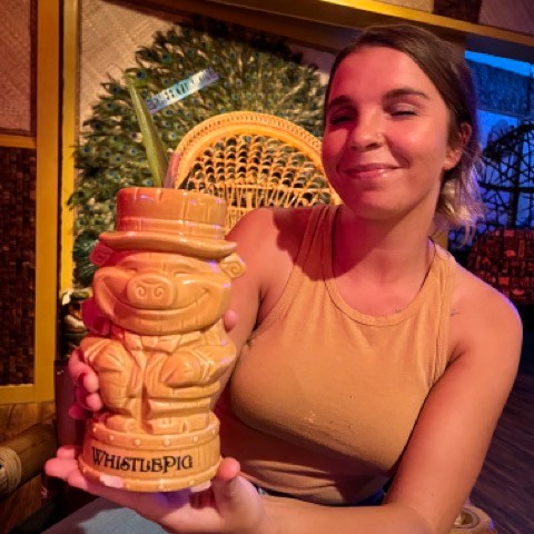 a woman sitting at a table posing for the camera