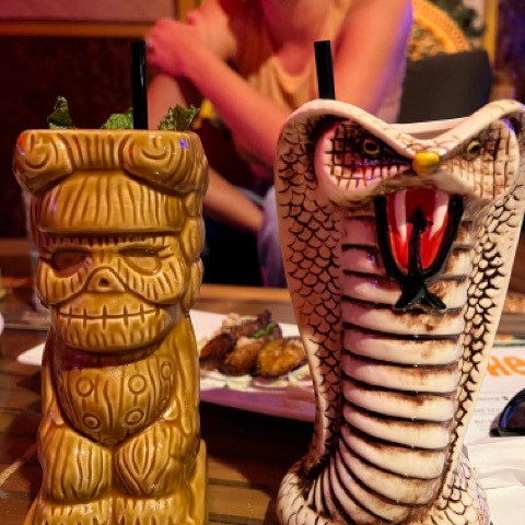 a person standing in front of a cake