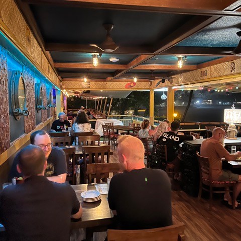 a group of people sitting at a table in a restaurant