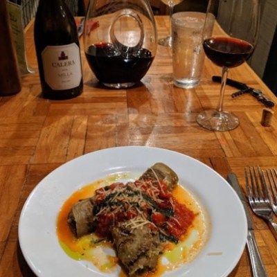 a plate of food with a glass of wine