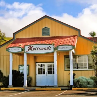 an empty parking lot in front of a house