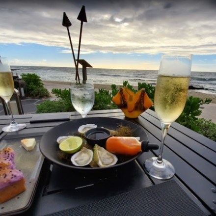 a plate of food and a glass of wine