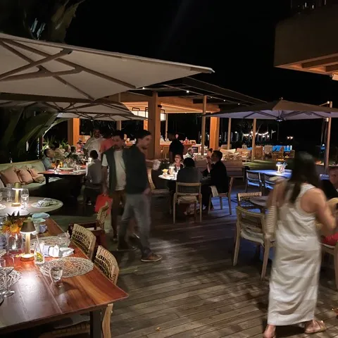 a group of people standing around a table in a restaurant