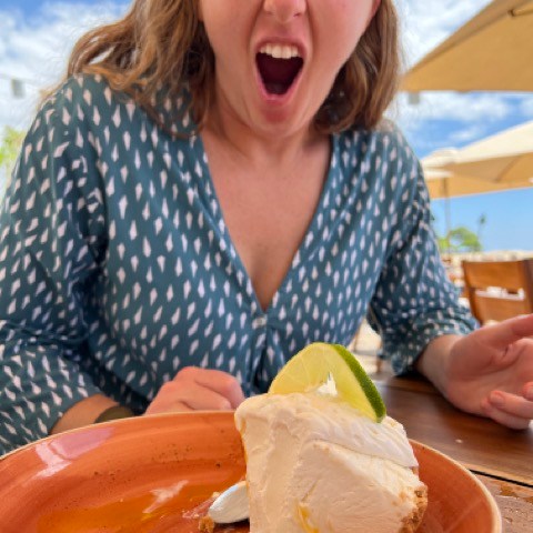a woman sitting at a table eating food