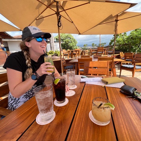 a person sitting at a table eating food