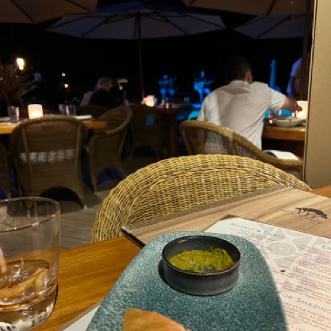 a person sitting at a table in a restaurant
