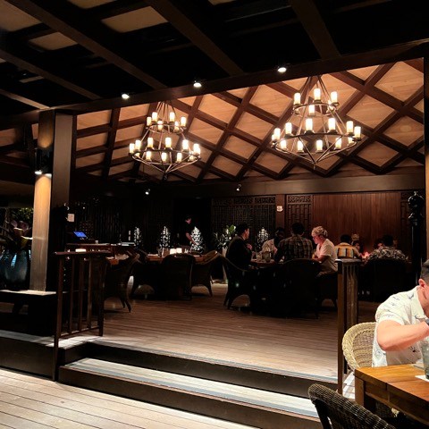 a person sitting at a table in a restaurant