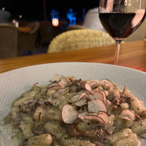 a plate of food and a glass of wine