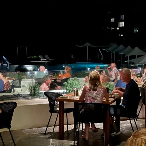 a group of people sitting at a table in a restaurant