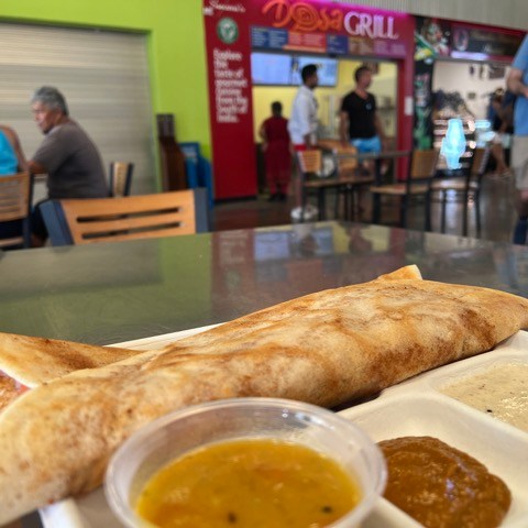 a plate of food with a sandwich and a cup of coffee