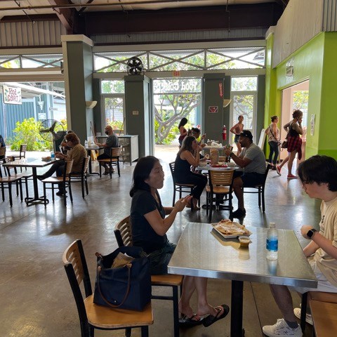 a group of people sitting at a table in a restaurant