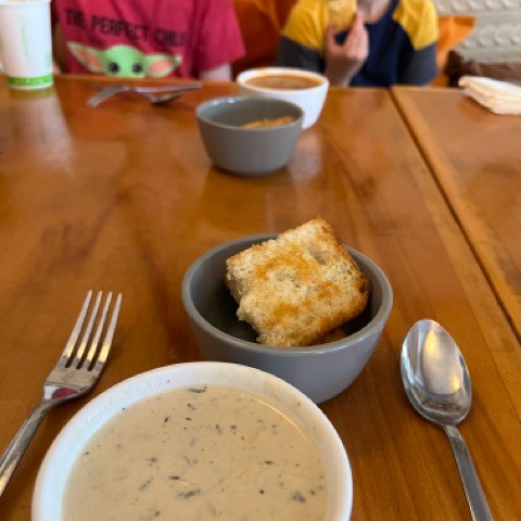 a bowl of food on a plate on a table